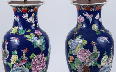A pair of Chinese blue-ground vases decorated with peacocks,...
