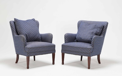 A pair of armchairs, over-upholstered with a blue cover with a golden pattern