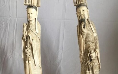 A pair of dignitaries in ivory on their...