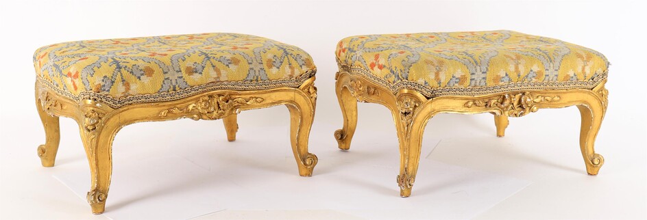 A pair of early Victorian giltwood footstools