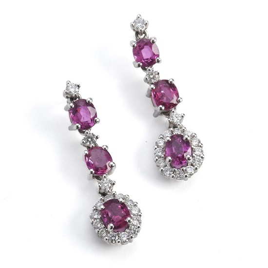 A pair of ruby and diamond ear pendants with oval-cut...