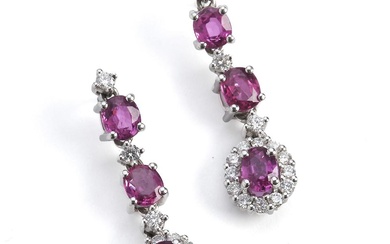 A pair of ruby and diamond ear pendants with oval-cut...