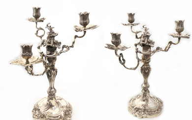 A pair of silver candlabras for 3 candles, falling...