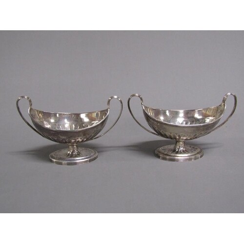 A pair of silver two handled table salts of boat shaped form...