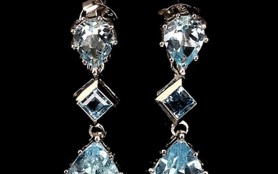 A pair of topaz ear pendants each set with an emerald-cut and two pear-shaped topazes, mounted in rhodium plated sterling silver. L. 3.4 cm. (2)
