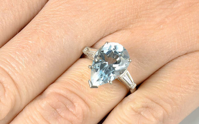 A platinum aquamarine single-stone ring, with tapered baguette-cut diamond shoulders, by Kutchinsky.
