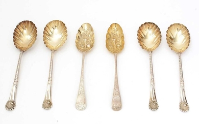 A set of four late Victorian silver fruit serving spoons; and a pair of silver berry tablespoons.