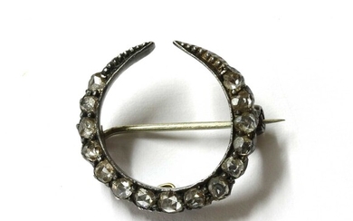 A silver and gold, diamond crescent brooch
