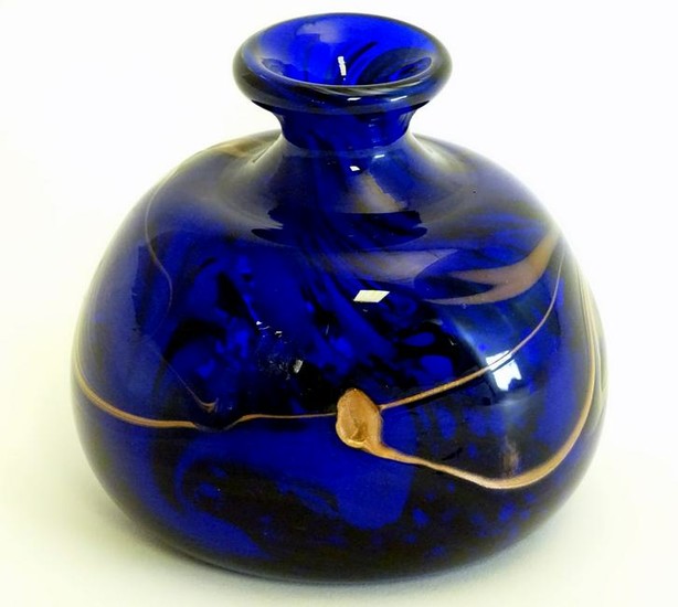 A studio glass vase with blue and bronze coloured swirl