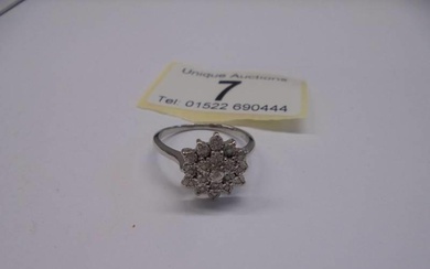 A three quarter carat white gold floral diamond ring, size N...
