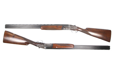 A true pair of AYA over and under 12 gauge shotguns.