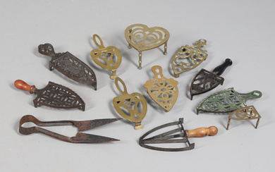 AN INTERESTING COLLECTION OF CAST IRON TRIVETS AND IRON STANDS.