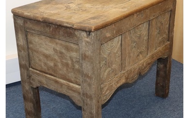 An 18th Century small oak coffer with triple panelled carved...