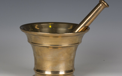 An 18th century bell metal pestle and mortar, length of pestle 24cm, height of mortar 14.3cm.