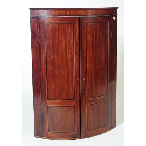 An early 19th century George III mahogany corner cabinet. Th...