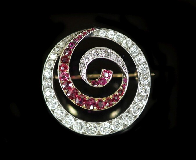 An early 20th century gold and silver, graduated ruby and diamond set open work whorl...