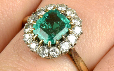 An emerald and brilliant-cut diamond cluster ring.