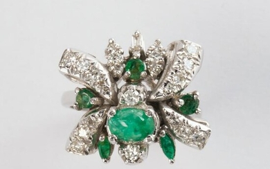An emerald and ten karat white gold ring