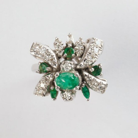 An emerald and ten karat white gold ring