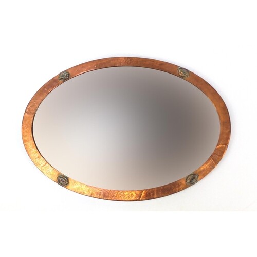 Arts & Crafts oval copper wall mirror with bevelled glass, 8...