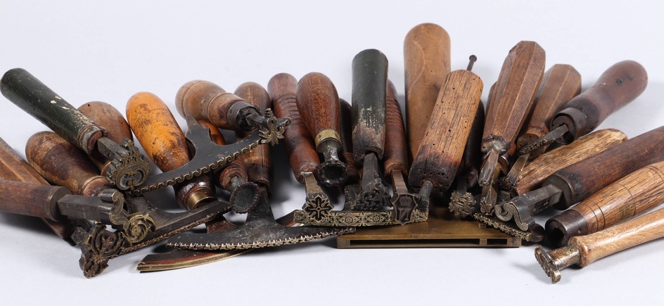 [Bookbinder's tools]. Lot of ±25 copper binding stamps, 18th-19th cent.,...