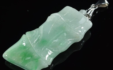 Carved jade pendant with 18K white gold mounts. Carved