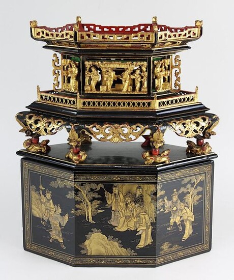 Chinese lacquer and wood work, around 1900, elongated octagonal basic form, on a flat plinth 8 feet resting on fully plastic dragon figures, on top of this architectural structure with 6 fully plastic openwork carvings of figures, scenes and flower...