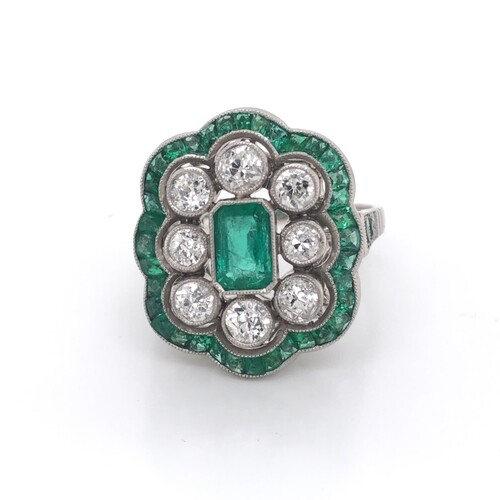 Diamond and emerald ring in platinum mount. Central emerald ...