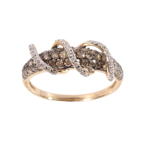 ORUMIA: A WHITE AND CHOCOLATE DIAMOND RING on a 14K yellow g...
