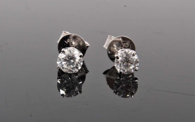 Pair of diamond single stone stud earrings, each with a round brilliant cut diamond in four claw 14ct white gold setting