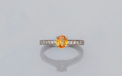 Solitaire ring in white gold, 750 MM, set with an oval yellow sapphire weighing 0.80 carat and set with two lines of brilliants, size: 53, weight: 3.75gr. gross.