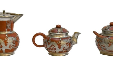 A 20th century Chinese three-piece pewter mounted Yixing tea...