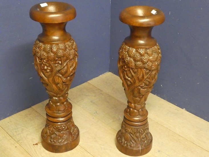 Two carved wooden urns 80cm height