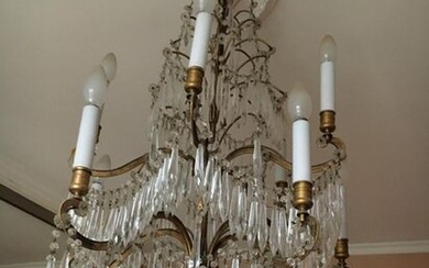 Two chandeliers (slight differences) in gilded metal with...