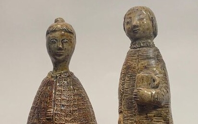 Two statuettes in salted sandstone, one representing a woman holding a basket (repair) signed J. LERAT, the other representing a man holding a jug.