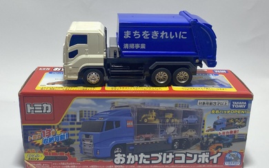 Two truck toys marked Takara Tomy etc.