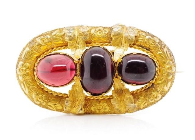 Victorian garnet and yellow gold brooch with repousse flower...