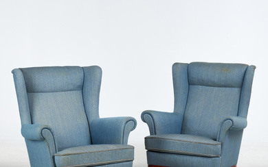 1 pair of ear-flap armchairs, first half of the 20th century, upholstered in blue textile.