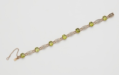 A 14k red gold platinum and peridot bracelet.