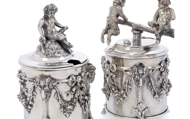 A 19th century French mustard and pepper-grinder, 950 standard, maker CM, the cylindrical body of each applied with floral swags and goat masks extending to three cloven feet, the handle of the grinder designed as two fauns playing on a rotating...