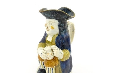 A 19thC Staffordshire pottery character Toby jug decorated i...