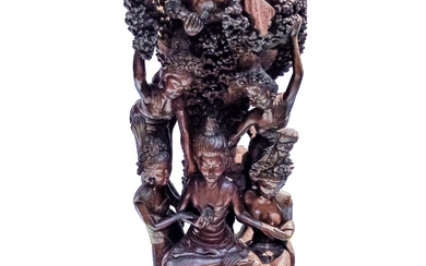 A 20th century carved roots wood group of figures surrounding with meditation seated