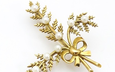 A 9ct gold brooch of foliate form with seed pearl and bow de...