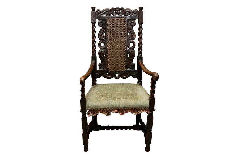 A CAROLEAN STYLE CARVED OPEN ARMCHAIR