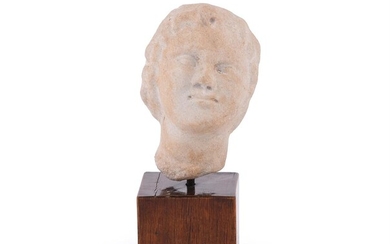 A CARVED MARBLE HEAD OF A CHILD, IN THE 1ST/2ND CENTURY AD ROMAN MANNER