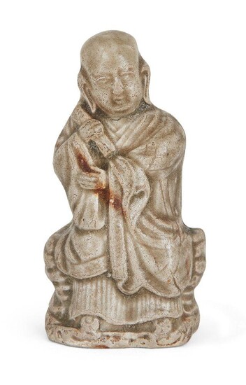 A Chinese Yaozhou celadon-glazed figure of a monk, Song dynasty, modelled seated with long flowing robes and a scroll in his right hand, 8.5cm high Provenance: Albert & Leonie van Daalen Collection; Ben Janssens Oriental Art, London, 3 April 2014.