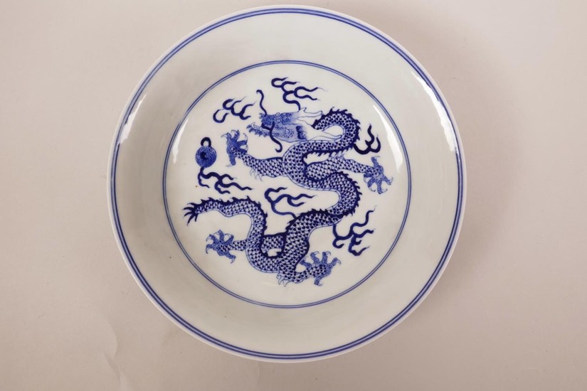 A Chinese blue and white porcelain dish decorated with drago...