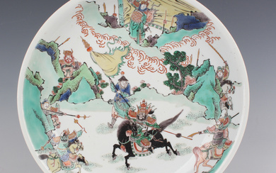 A Chinese famille verte porcelain saucer dish, Kangxi style but later, painted with a battle scene