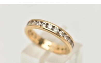 A DIAMOND FULL ETERNITY BAND RING, a yellow metal band ring,...