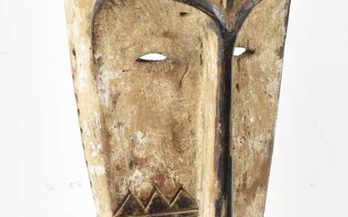 A Fang, Gabon, elongated mask with white pigmentation detail, presented...